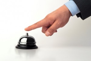 image of a hand ringing a service bell
